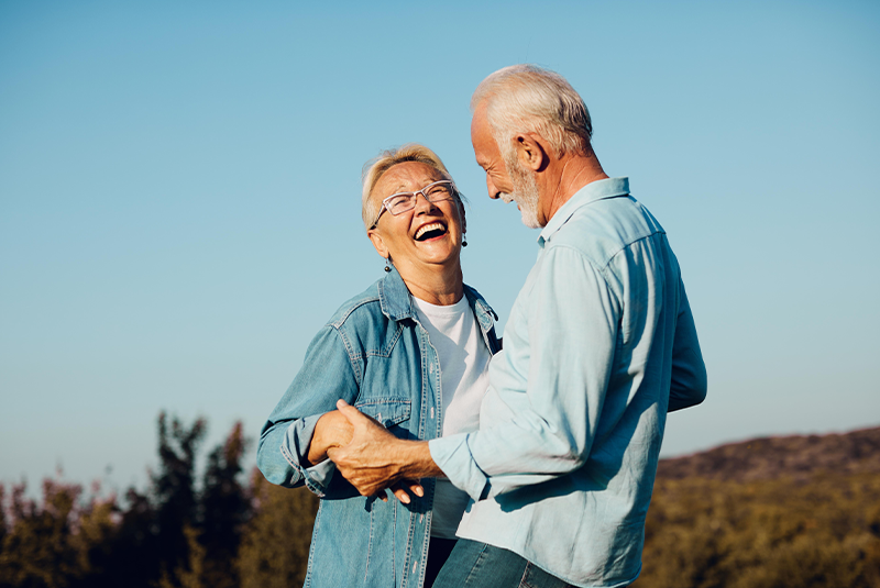 smiling couple holding hands.
